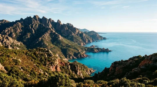 Dramatic Corsican coastal landscape with rugged mountains meeting turquoise Mediterranean waters